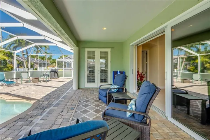 View of patio with french doors, an outdoor pool, and a lanai