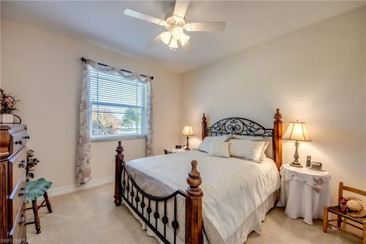 Bedroom featuring light colored carpet and a ceiling fan