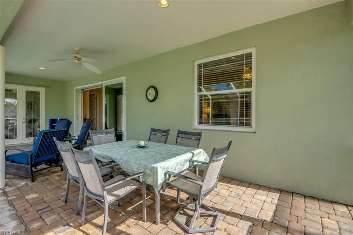 View of patio / terrace featuring a ceiling fan, french doors, and outdoor dining area