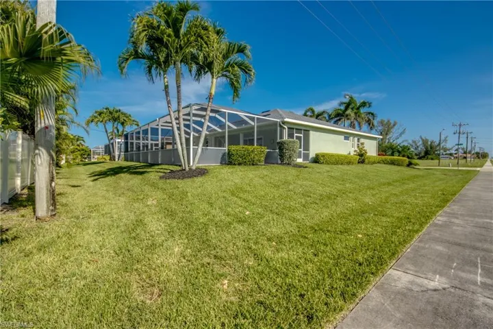 View of green lawn with a lanai