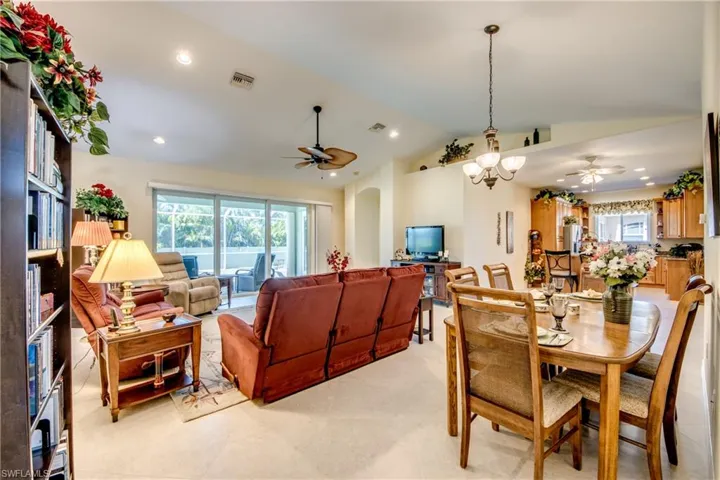 Dining space featuring ceiling fan, vaulted ceiling, recessed lighting, and arched walkways