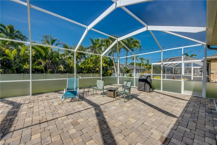 View of patio / terrace with area for grilling and glass enclosure