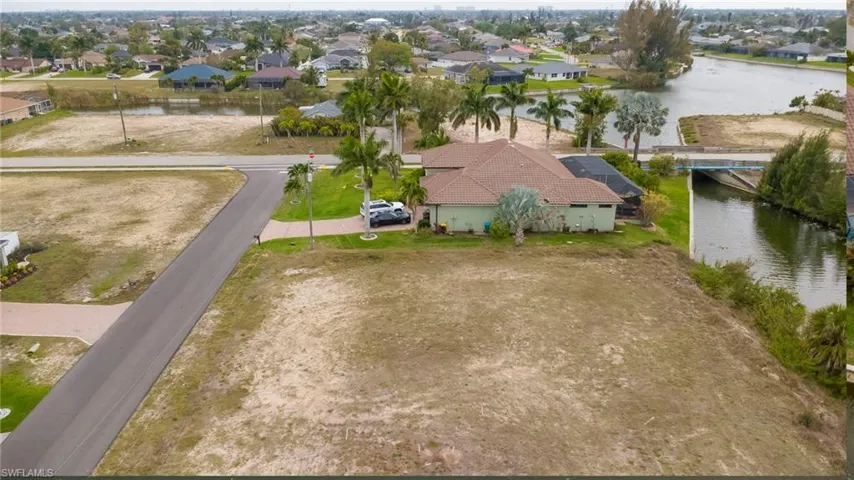 Aerial view of residential area featuring a nearby body of water