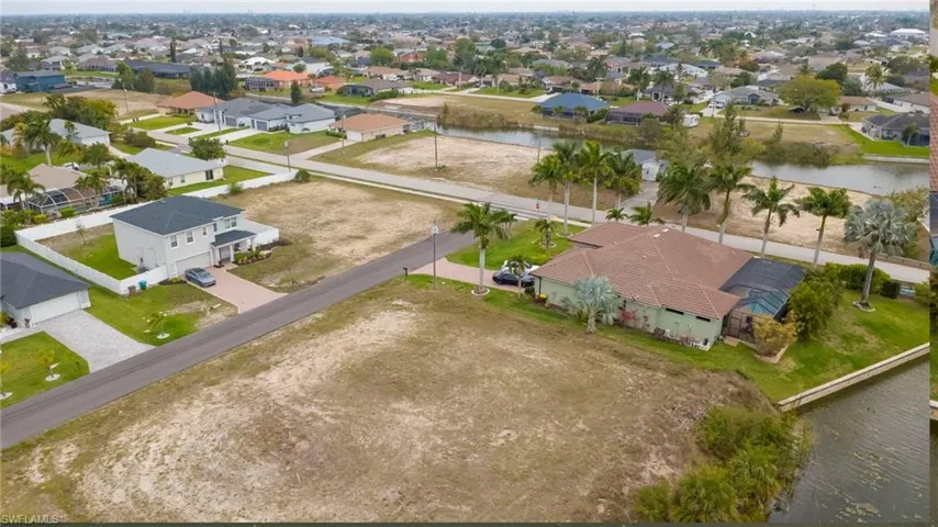Aerial perspective of suburban area featuring a large body of water