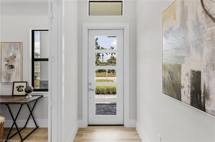 Foyer with wood finished floors and baseboards