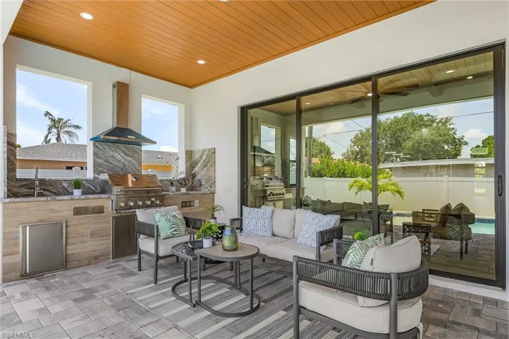 View of patio featuring an outdoor living space and a sink