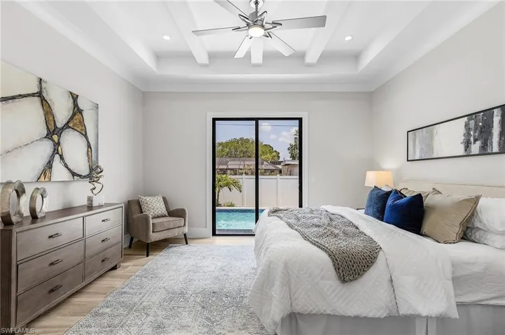 Bedroom with access to exterior, light wood-type flooring, beam ceiling, recessed lighting, and ceiling fan