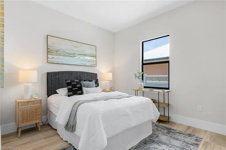Bedroom featuring light wood-style floors and baseboards