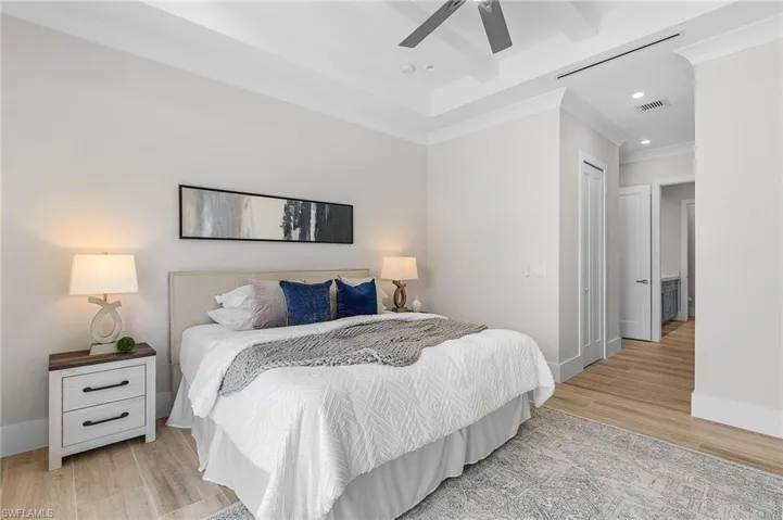 Bedroom featuring recessed lighting, wood finished floors, baseboards, a ceiling fan, and ornamental molding