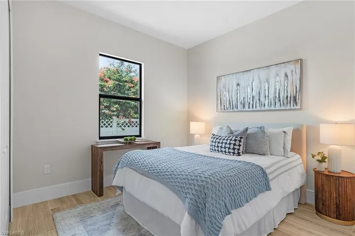 Bedroom featuring light wood-style flooring and baseboards