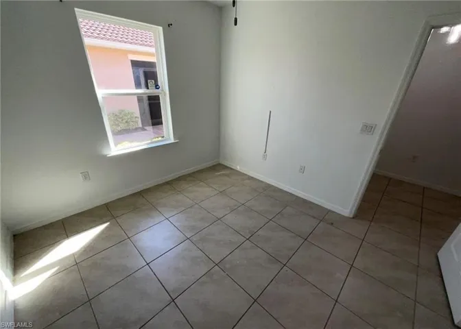 Room featuring tiled flooring and a window providing natural light