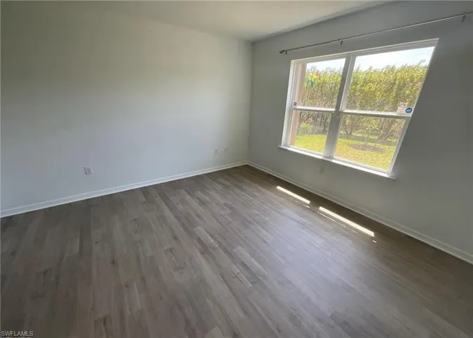 This room features light-colored walls and wood-look flooring