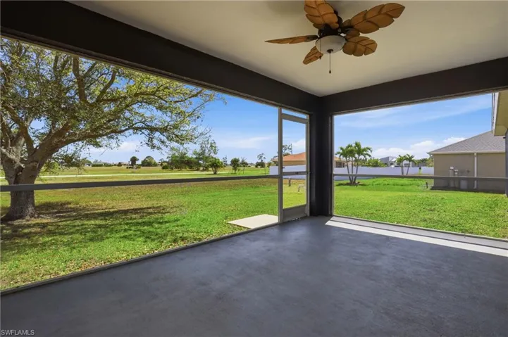 Unfurnished sunroom with ceiling fan