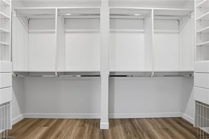 Walk in closet with light wood-style flooring