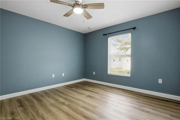 Empty room featuring a ceiling fan and light wood-style flooring