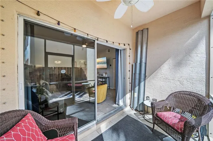 The property features a private outdoor patio with a textured wall finish and a ceiling fan