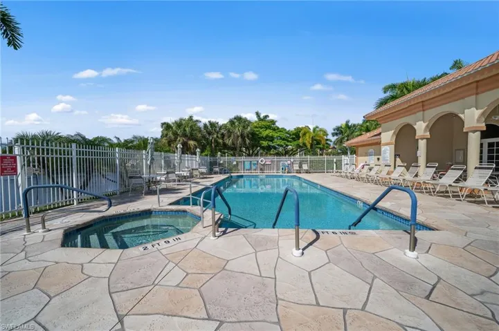 The property features a swimming pool with an integrated spa, surrounded by a flagstone patio
