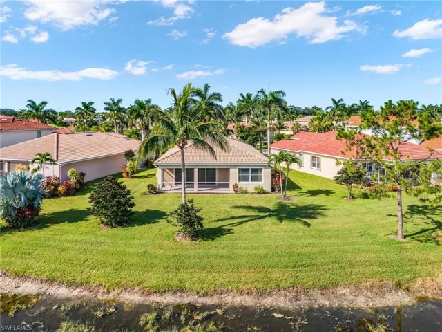 Rear view of property with a yard