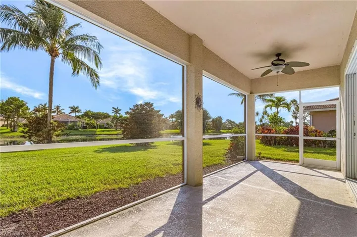 Screened in Lanai featuring ceiling fan and a water view