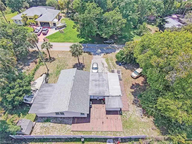 The property features a shingled roof and a wooden deck