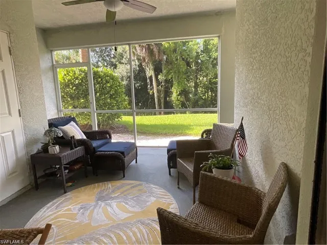 Screened lanai with a ceiling fan and healthy amount of natural light