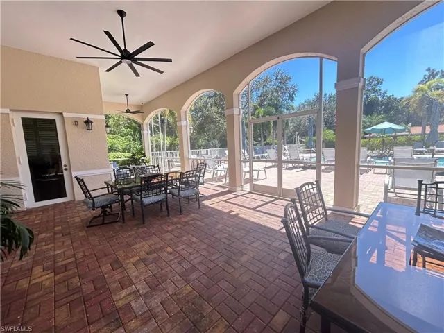View of patio with outdoor dining space and ceiling fan