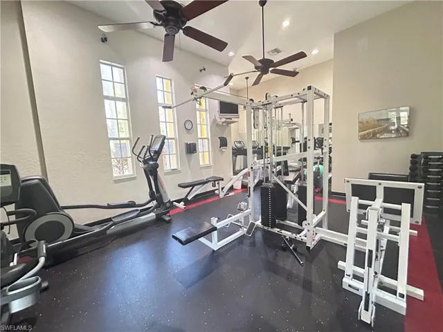 Exercise room with recessed lighting, ceiling fan, and a textured wall