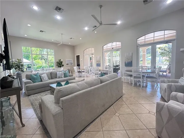 Living area featuring recessed lighting, light tile patterned flooring, and a ceiling fan