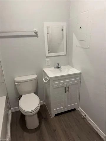 Primary Bathroom with vanity and dark wood finished LVP floors