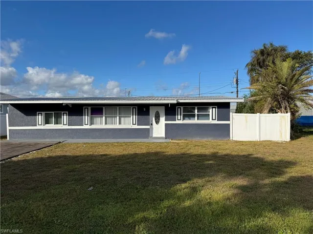 Ranch-style home featuring stucco siding and a metal roof - Front View
