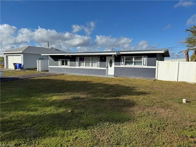 Ranch-style house with stucco siding - Front view from road