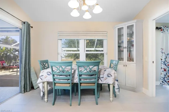 Dining space featuring a chandelier, plenty of natural light, and light tile patterned floors