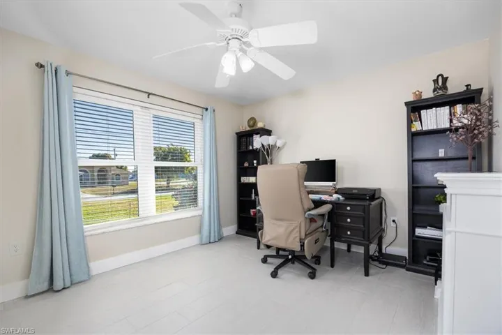 Office space with baseboards and a ceiling fan