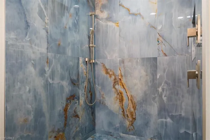Full bathroom featuring a marble finish shower