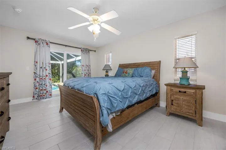 Bedroom featuring access to outside and a ceiling fan