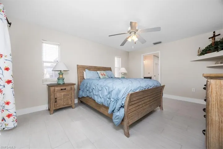 Bedroom with ceiling fan and light wood-style floors