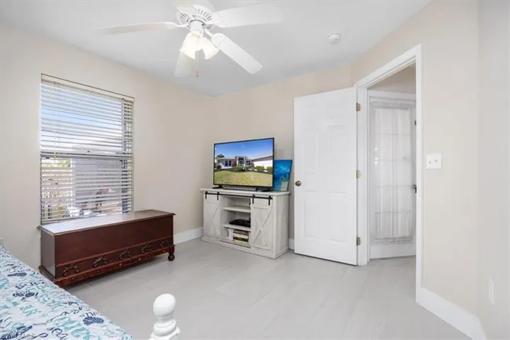 Bedroom with ceiling fan and light wood-type flooring