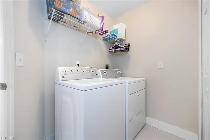 Laundry area featuring washer and clothes dryer and baseboards