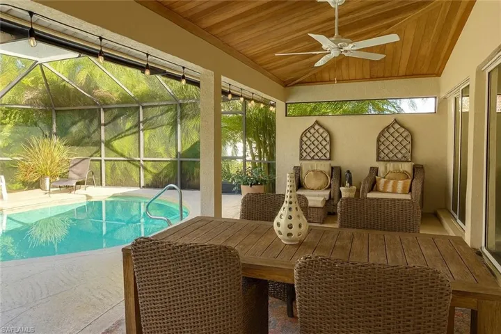 Swimming pool featuring a lanai and outdoor dining space