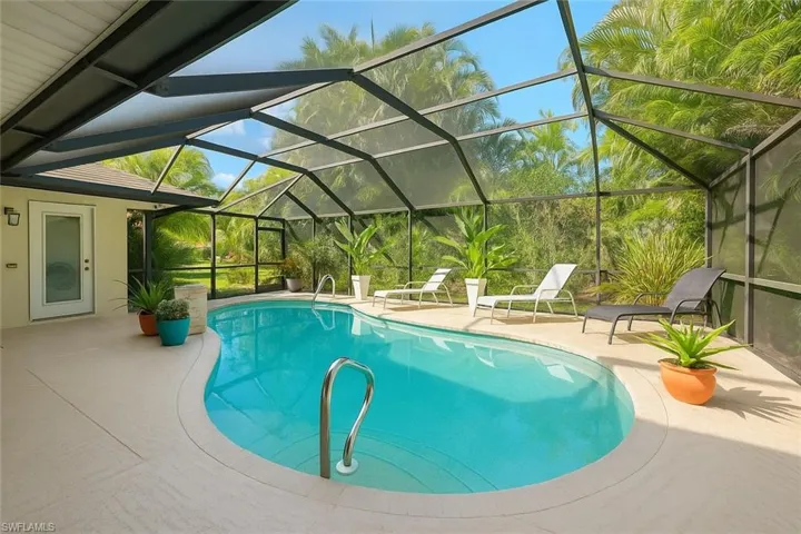 Swimming pool featuring an enclosed lanai
