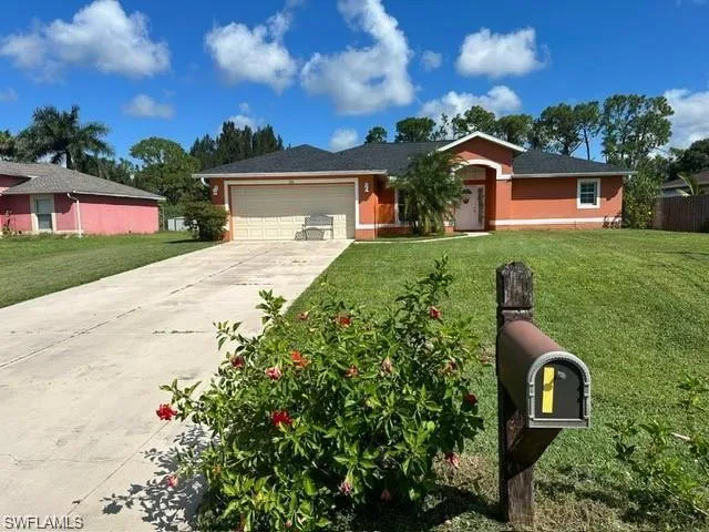 Ranch-style home with a garage and a front yard