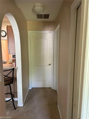 Hallway featuring carpet floors