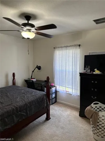 Bedroom featuring light carpet and ceiling fan