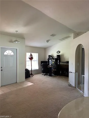View of carpeted entrance foyer