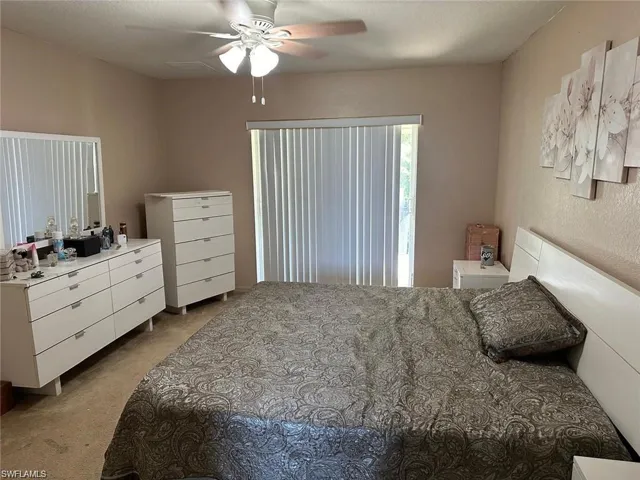 Carpeted bedroom with ceiling fan
