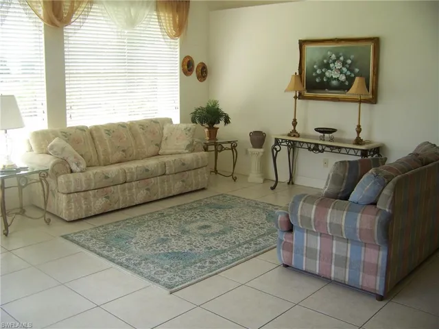 Tiled family room with lots of windows and a view of golf course.