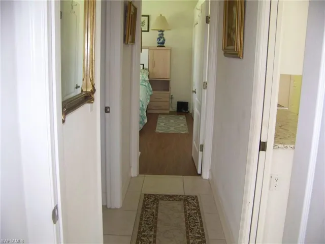 Hallway between to bedroom/bath and pocket door to right to close off kitchen if so desired.
