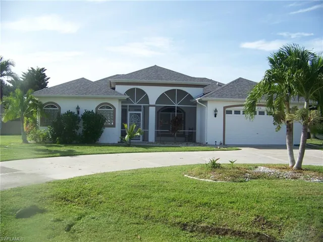 View of front of home featuring a garage and a front lawn