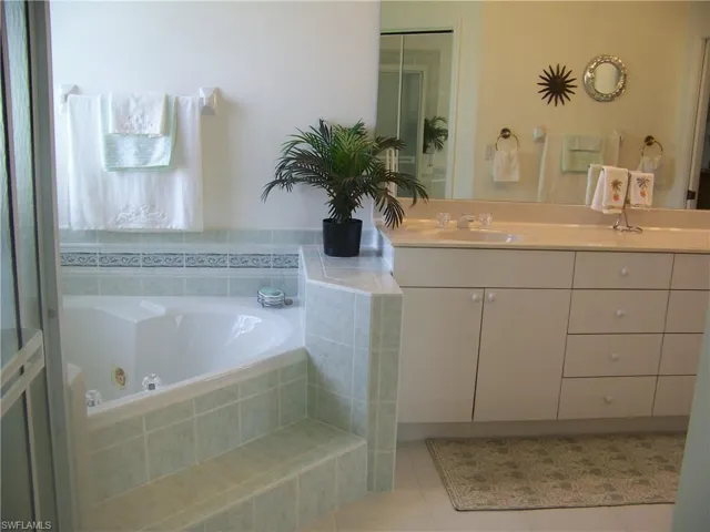 Bathroom featuring vanity, spa, shower etc. All in like new condition.