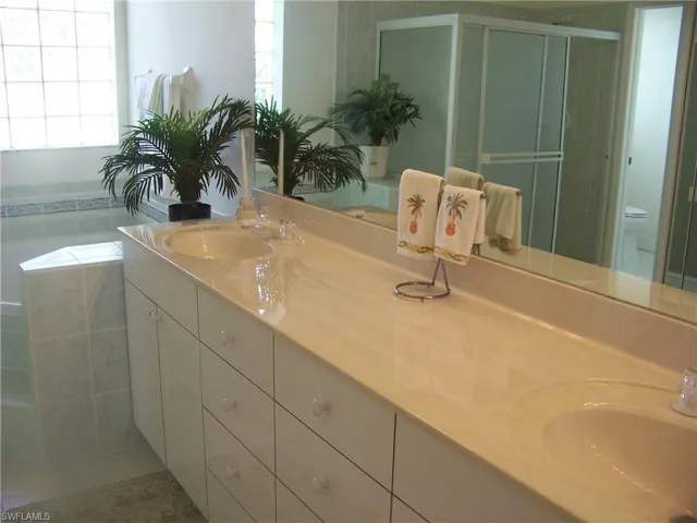 Master bath with dual marble sinks and lots of storage drawers and cabs.